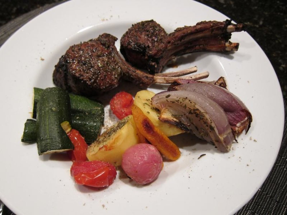 Lamb chops served with zucchini, potatoes, and roasted onions