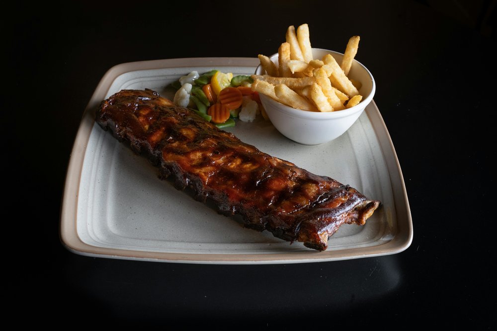 Glazed pork ribs with French fries and mixed vegetables