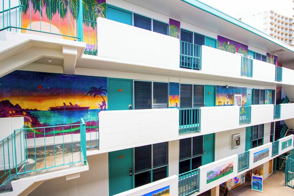 Exterior of Waikiki Beachside Hostel with colorful tropical mural