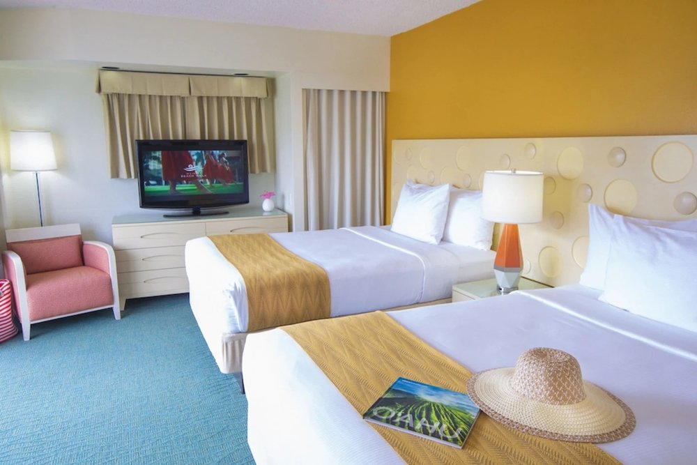 Bright double room at Coconut Waikiki Hotel with yellow accent wall