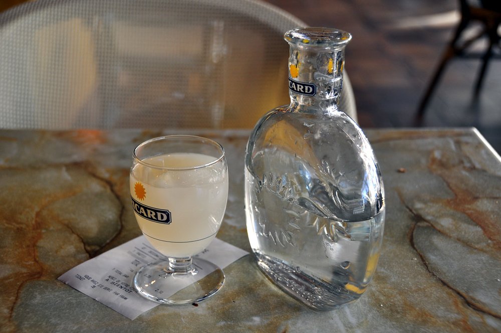 Glass and bottle of pastis on a café table in Paris | Photo Credit: Flickr