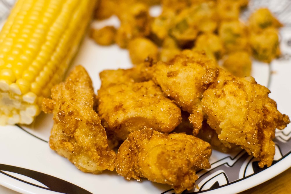 Southern fried catfish served with corn on the cob and fried okra