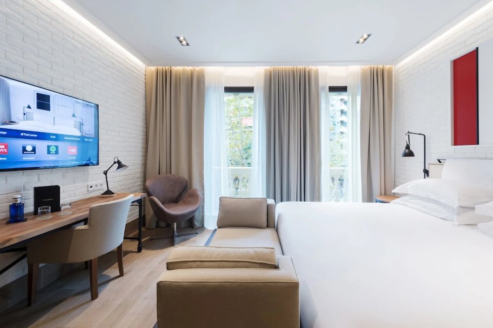The Corner Hotel Barcelona room with large windows and modern furnishings