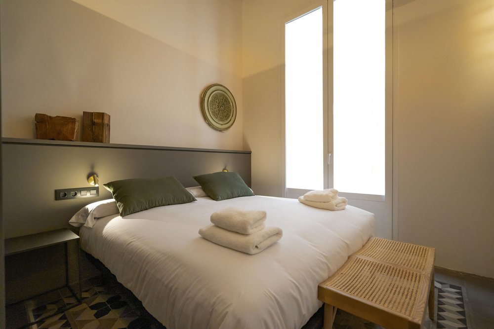 Porxos Garden Barcelona bedroom with natural light and minimalist decor