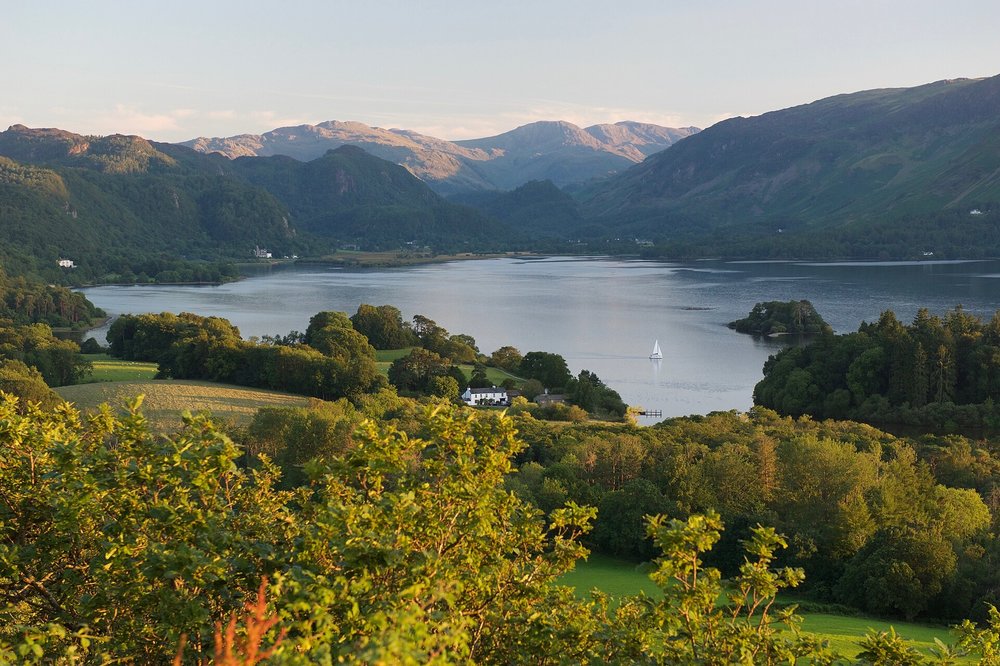 Tranquil view of the Lake District with green hills and a peaceful lake