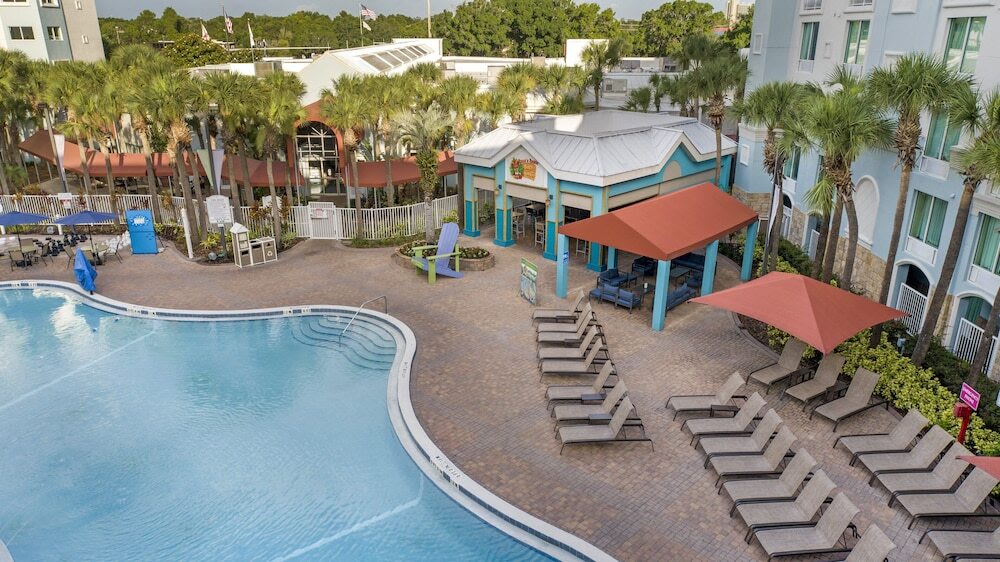 Poolside view of Holiday Inn Resort Orlando with sun loungers and a vibrant setting