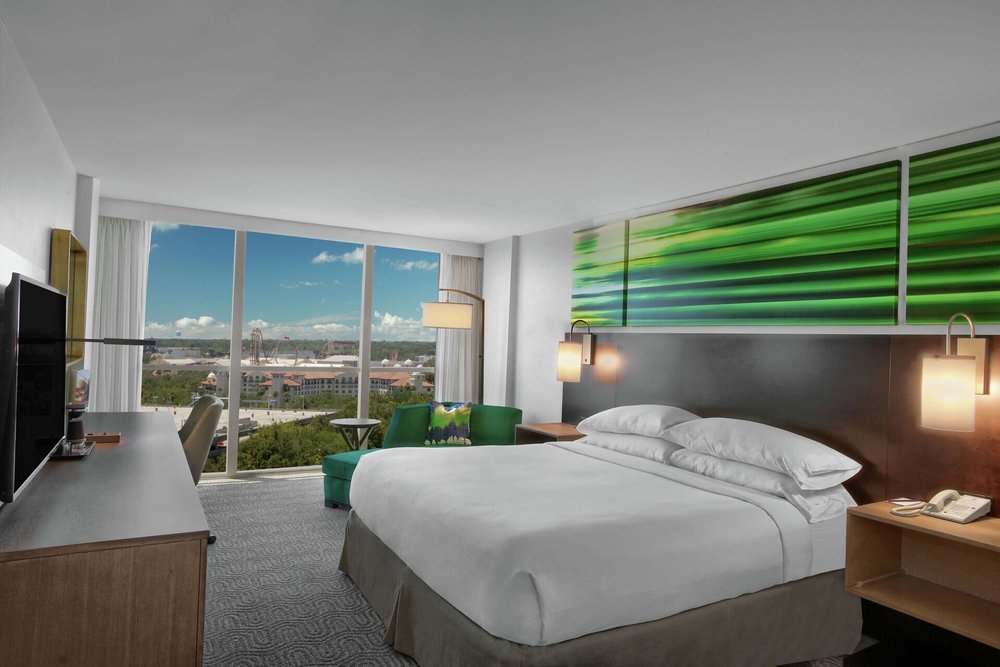 Elegant room at Doubletree Orlando featuring large windows and modern furniture