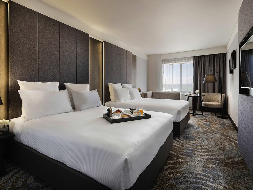 Pullman Rotorua guest room with two beds and contemporary design