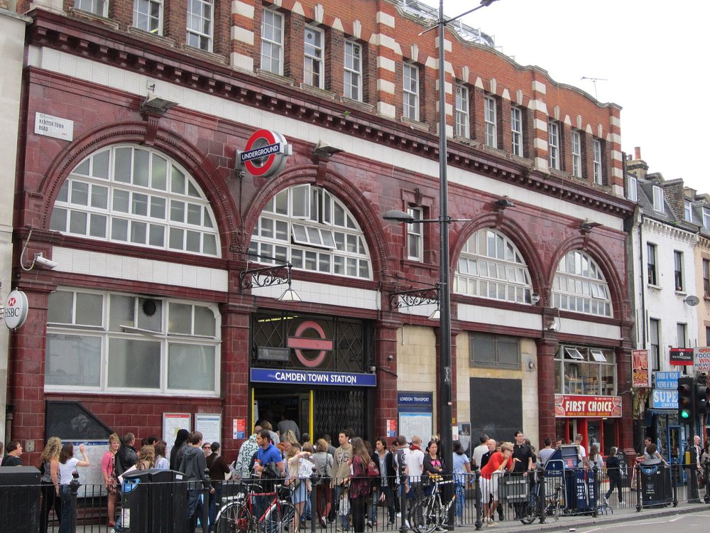 Camden Town Tube Station exterior, featuring crowds and nearby shops