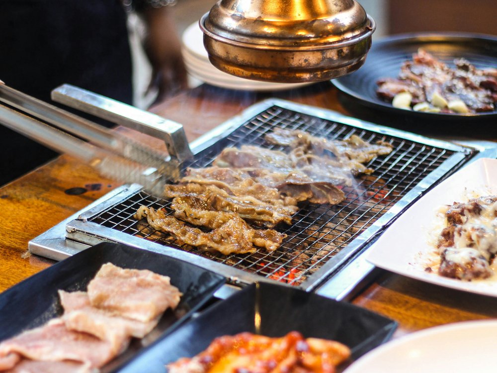 Grilling Korean BBQ meat on a charcoal grill 