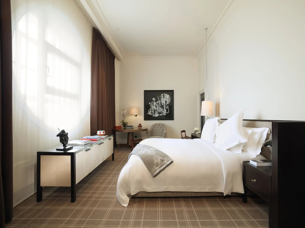 Modern hotel room with a clean design and large windows letting in natural light
