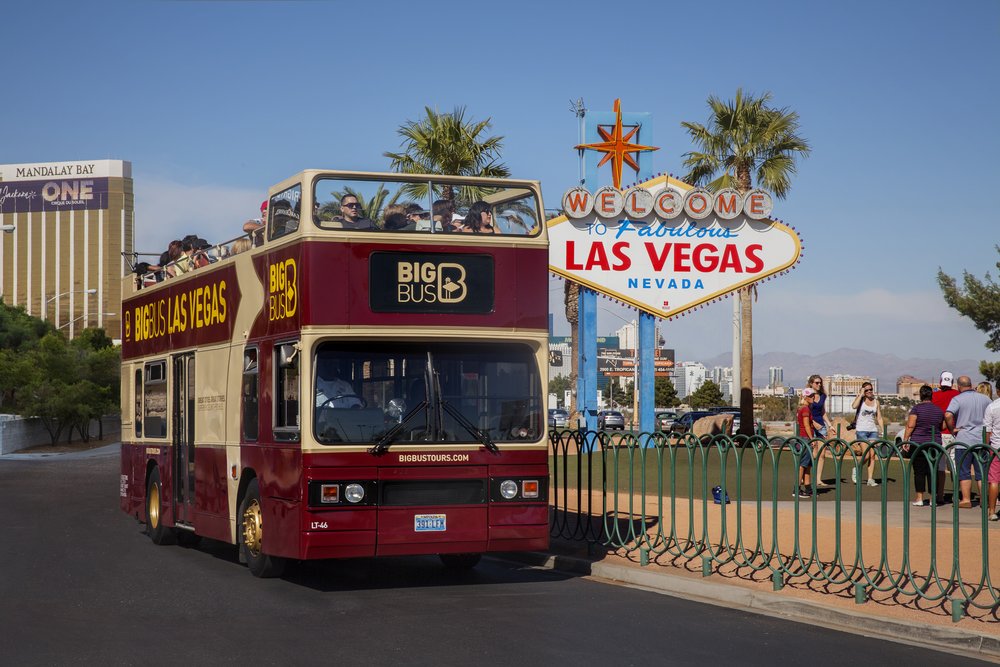 Big Bus hop-on hop-off tour bus driving past the Welcome to Fabulous Las Vegas sign