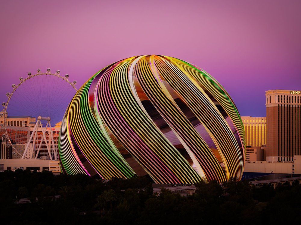  The Sphere in Las Vegas glowing with colorful LED lights at sunset