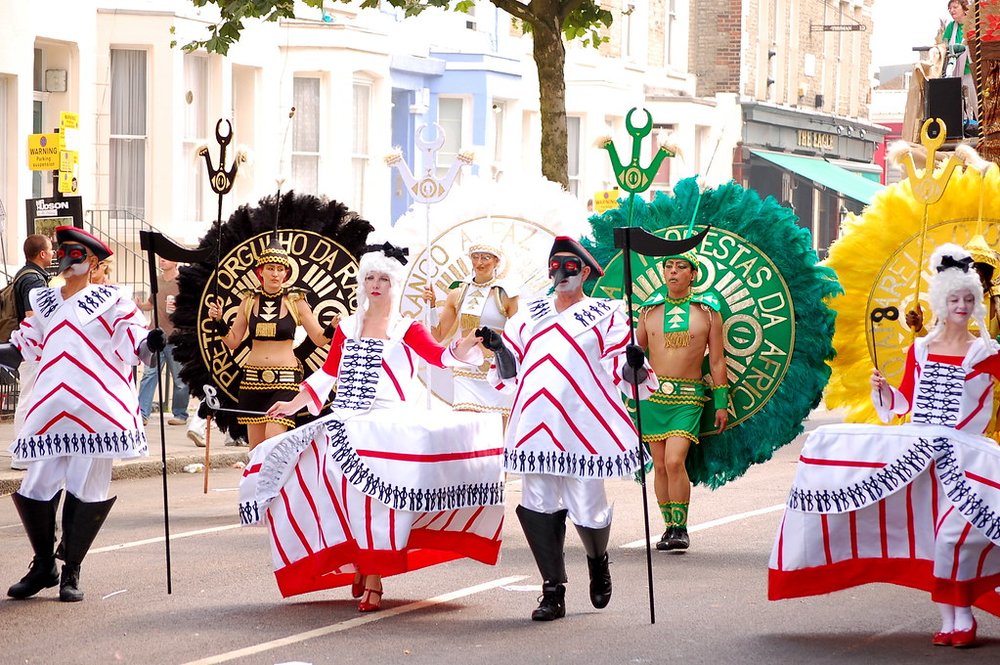  Dancers in vibrant costumes leading the Notting Hill Carnival parade | Photo Credit: Flickr