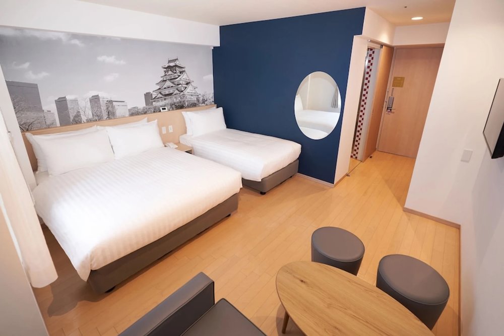 Bright twin room at Travelodge Honmachi Osaka with Osaka Castle wall art