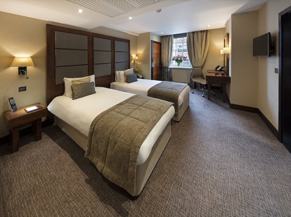 Comfortable twin room at Wellington Hotel by Blue Orchid with elegant decor and modern amenities