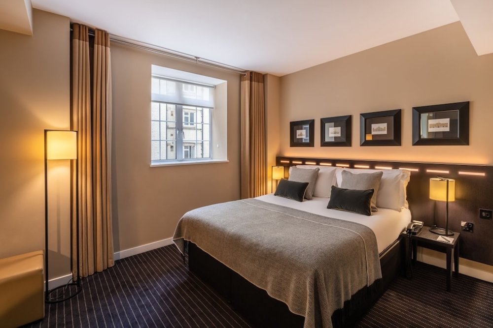 Elegant and cozy room at The Resident Victoria with modern furnishings and a warm atmosphere