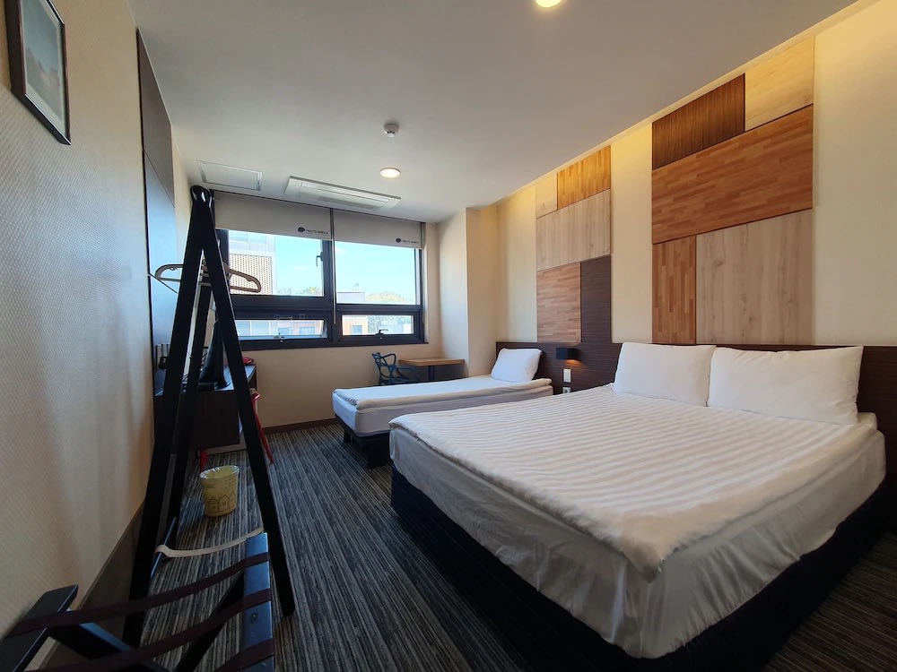 Spacious twin room with wooden wall design at Bound Hostel Seoul