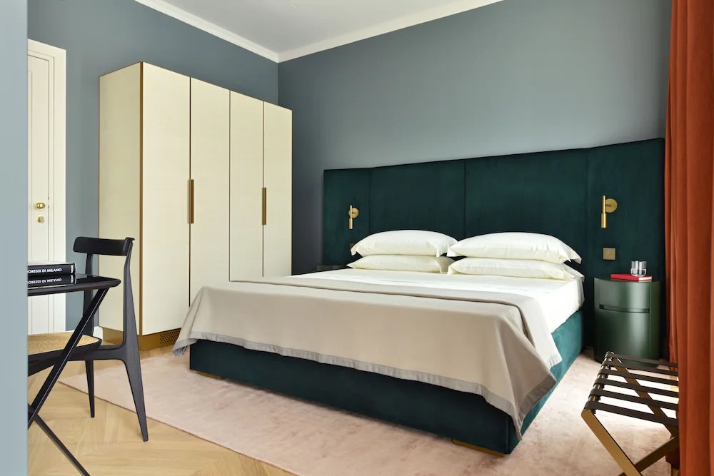 Elegant bedroom at Casa Brivio in Milan with modern decor and cozy green accents