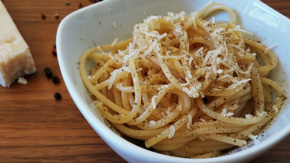 A simple bowl of spaghetti topped with Pecorino Romano cheese and black pepper | Photo Credit: Wikimedia Commons