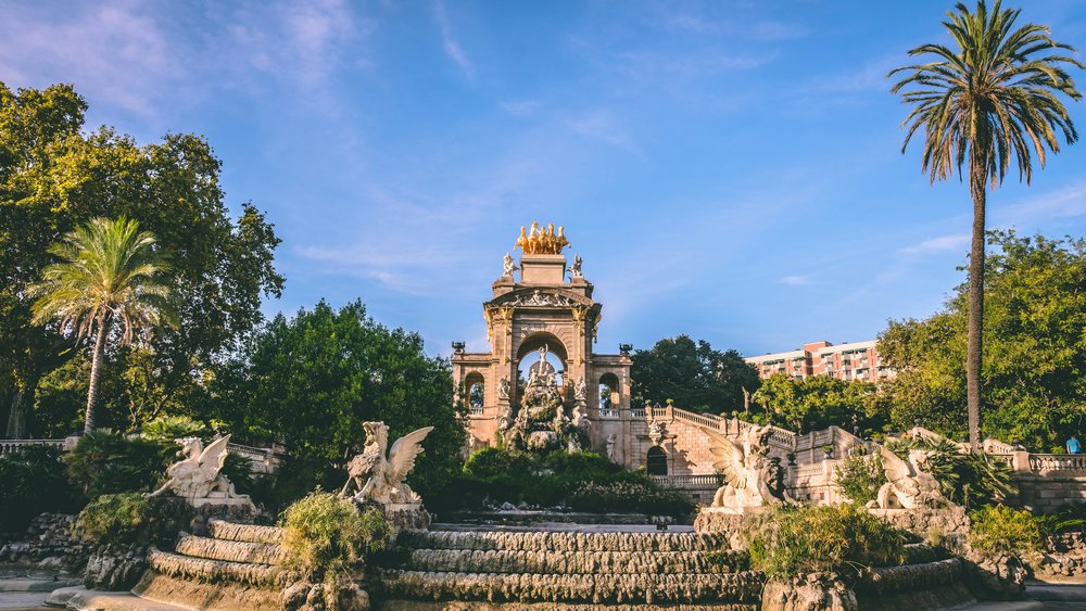 Monumental fountain at Parc de la Ciutadella with palm trees and sculptures
