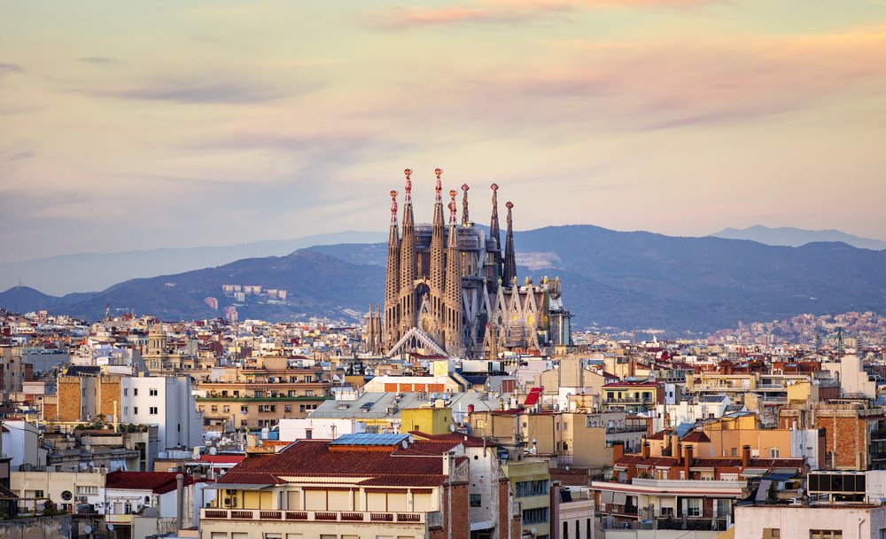 Aerial view of Sagrada Familia towering over Barcelona cityscape
