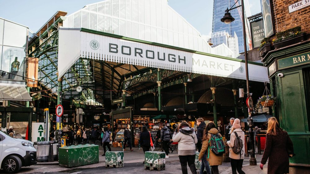 Borough Market entrance in London with shoppers walking in
