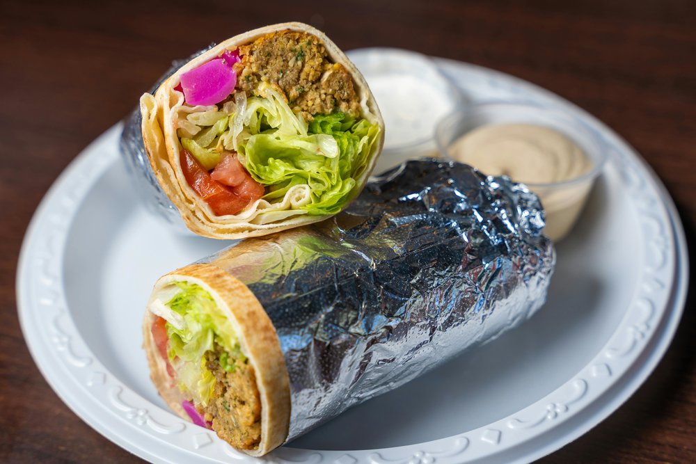 Fresh falafel wrap cut in half with tahini sauce | Photo Credit: Snappr on Pexels