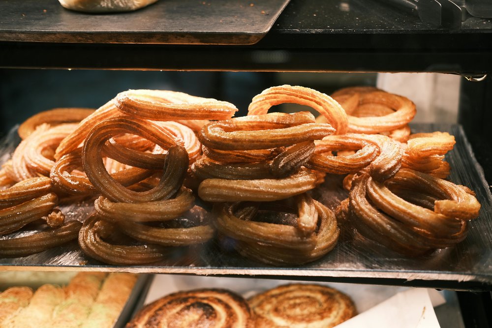 Freshly fried churros displayed at market stall | Photo Credit: Zeki Okur on Pexels