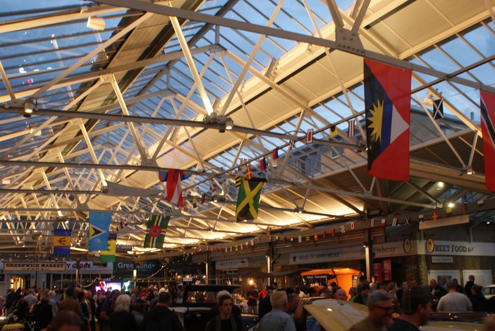 Greenwich Market indoor food stalls with flags overhead | Photo Credit: Wikimedia Commons