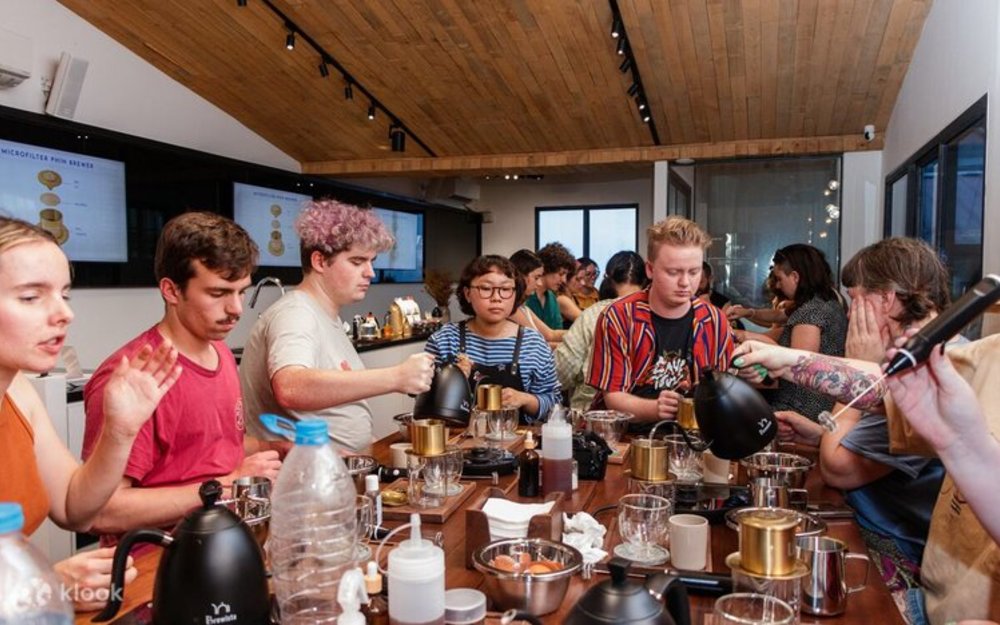 A group of people brewing coffee