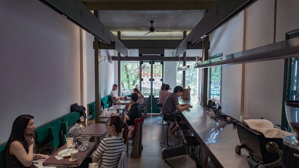 People seated and enjoying coffee in a coffee shop