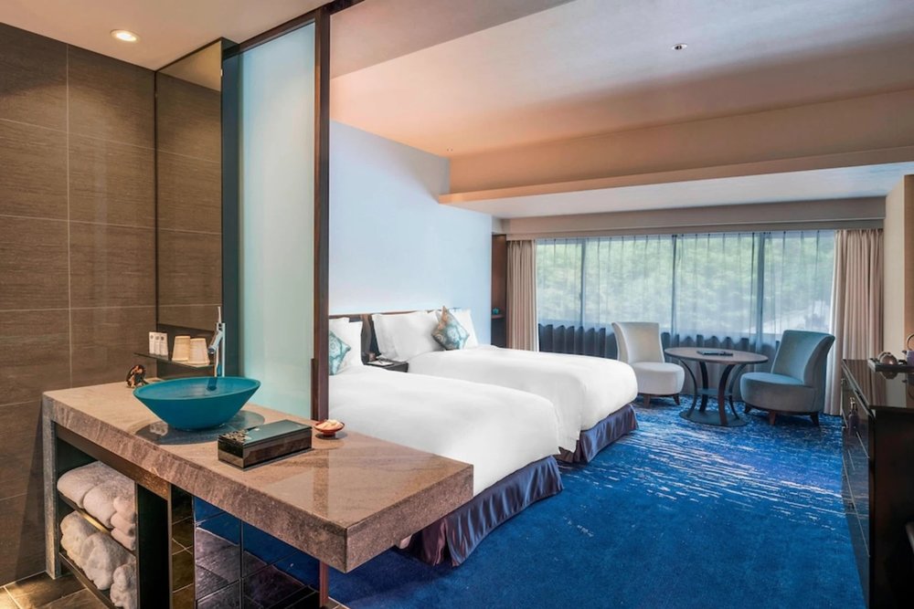 Japanese-style suite with tatami and wooden beams at Suiran Kyoto