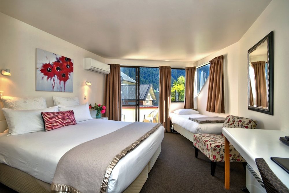 Bright room at Melbourne Lodge Queenstown with mountain views and cozy queen bed