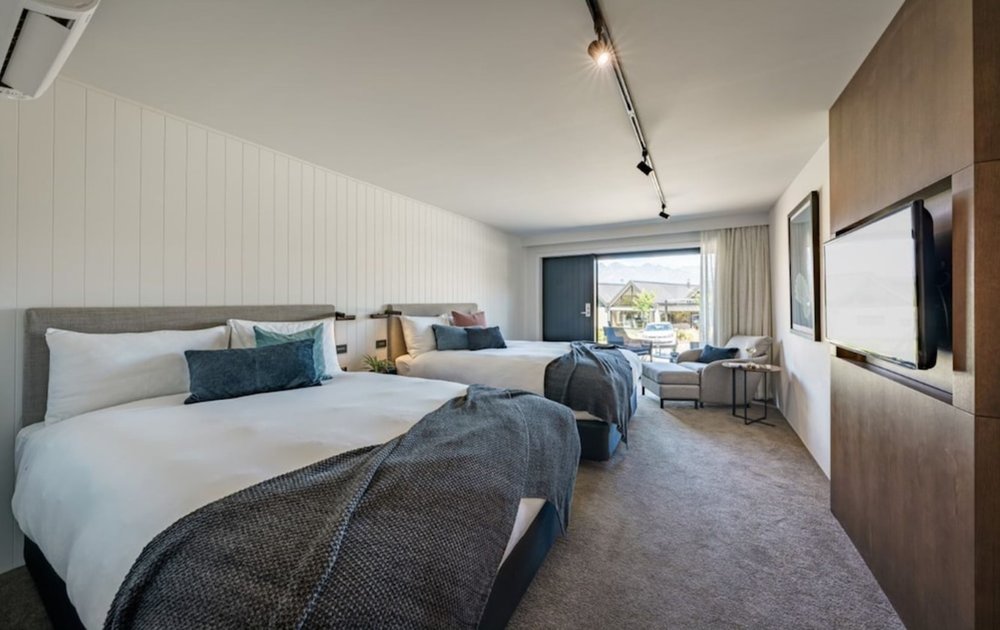 Modern twin room at Kamana Lakehouse with plush beds and garden views