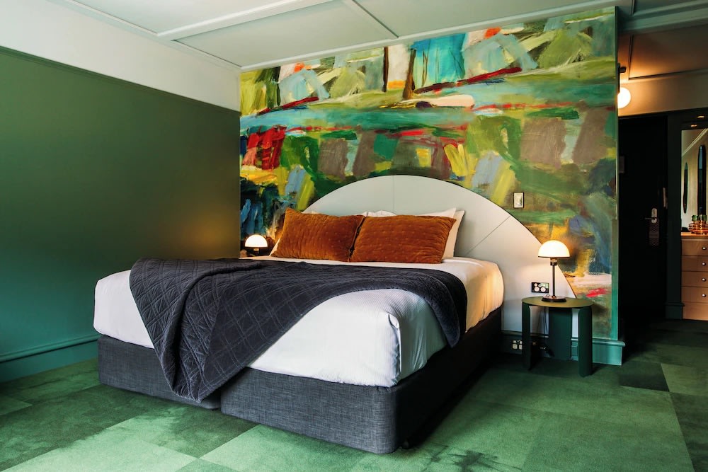 Bold designer room at The Central Hotel Queenstown with colorful mural and modern décor