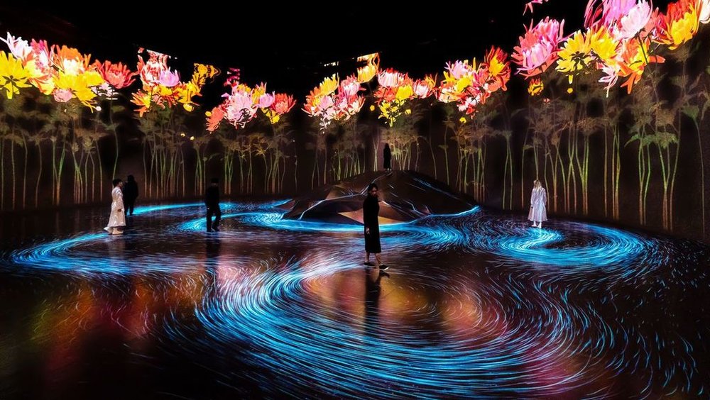 Immersive digital art glowing inside teamLab Borderless