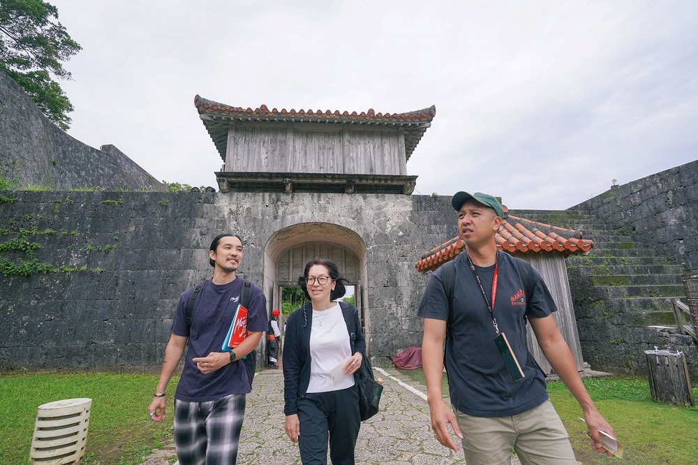 Visitors touring Shuri Castle historic site in Okinawa