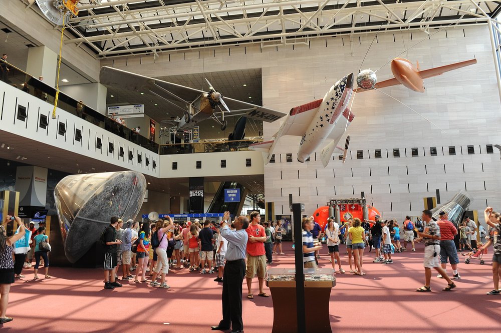 Visitors inside Smithsonian National Air and Space Museum with planes