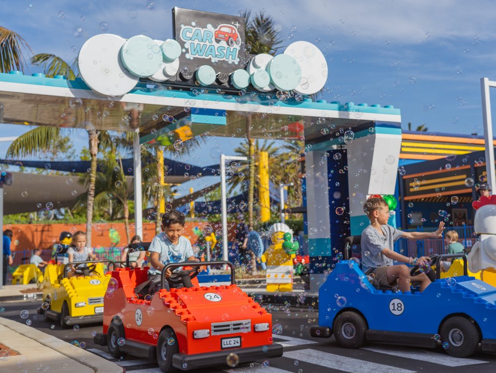 Children riding LEGO cars at LEGOLAND California theme park attraction