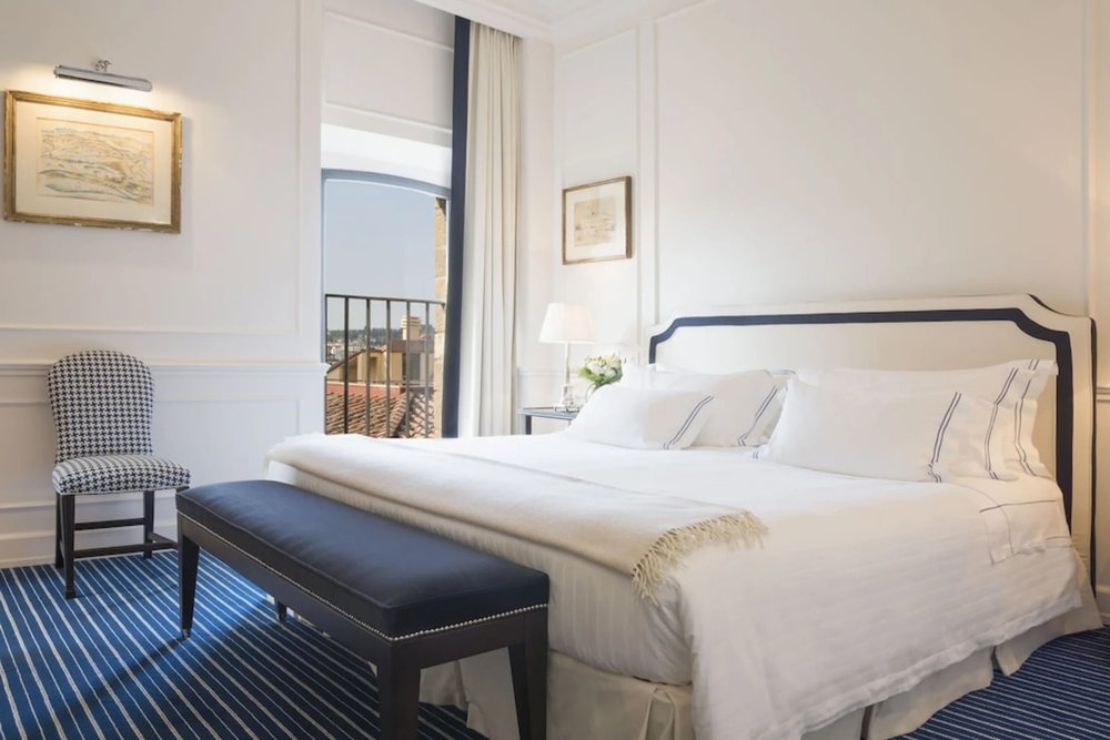 Luxury guest room at Hotel Lungarno Florence with balcony view and classic Italian decor