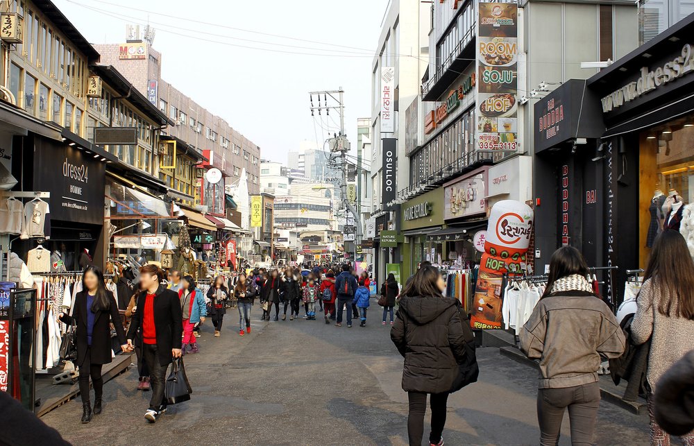 Hongdae street at night with neon signs and busy nightlife scene