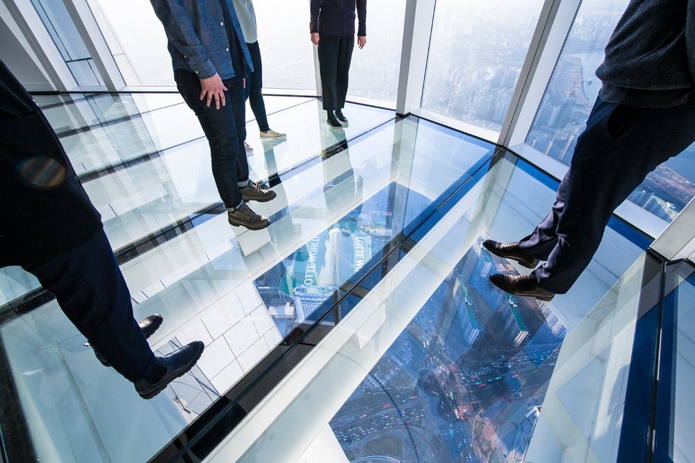 Visitors standing on Seoul Sky glass floor observation deck in Lotte World Tower