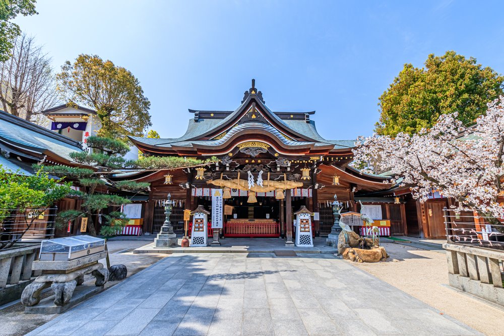 Kushida Shrine in Fukuoka with traditional architecture and cherry blossoms