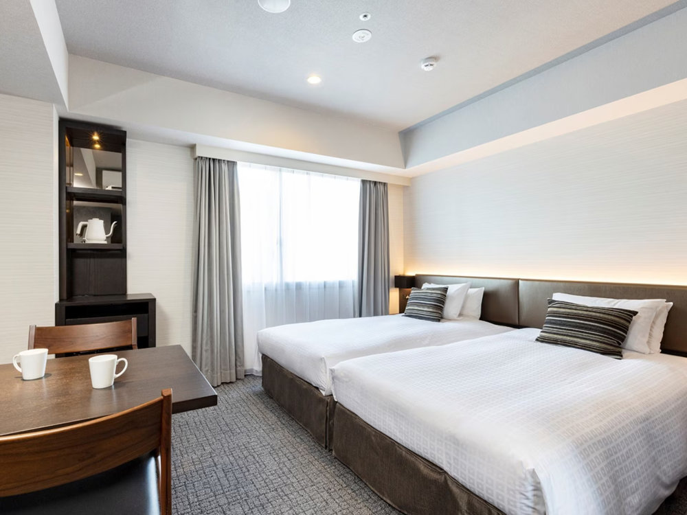 Tokyu Stay Hakata hotel room with two beds and modern amenities
