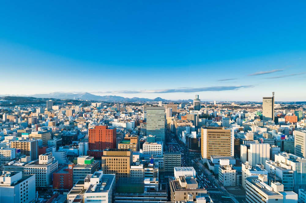 Aerial view of Sendai city skyline with buildings and mountains in Miyagi Japan