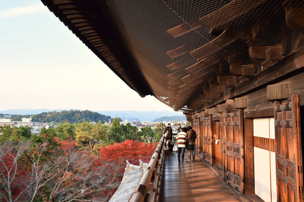 Wooden temple corridor overlooking autumn foliage at Nanzen-ji Temple in Kyoto