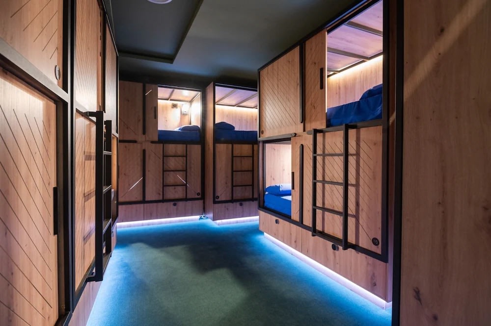 Minimalist capsule-style dorms at Hostel Ikigai, a stylish modern Seville hostel