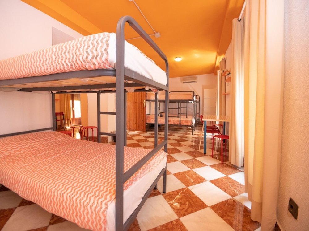 Bright dorm room with bunk beds at Arc House Sevilla, a budget-friendly Seville hostel stay