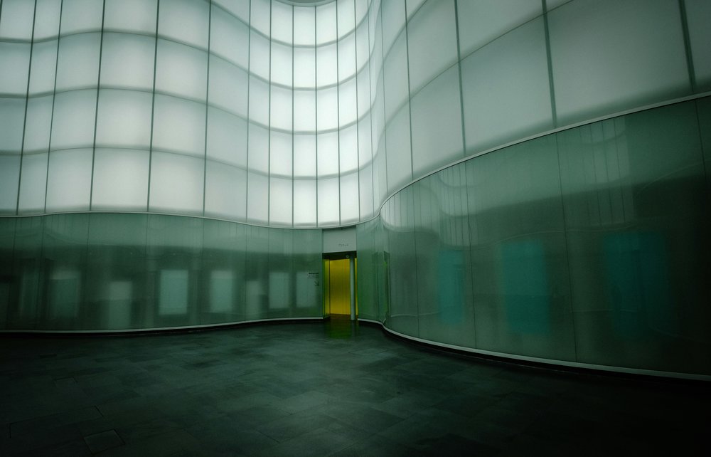 A modern entrance to a building surrounded by paneled walls.